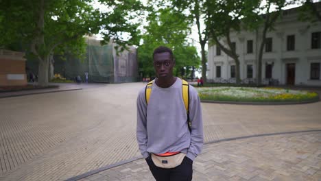 Handsome-Young-Man-Walking-In-City-With-Yellow-Backpack-On-Shoulders,-Wearing-Casual-Clothes-1