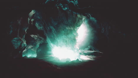 blue ice cave covered with snow and flooded with light