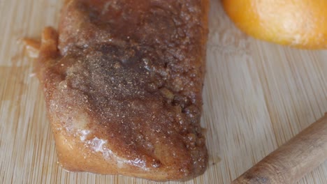 sweet cinnamon-coated torrijas drizzled with syrup, served on a wooden surface