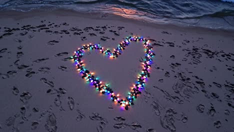 heart of lights on the beach at sunset