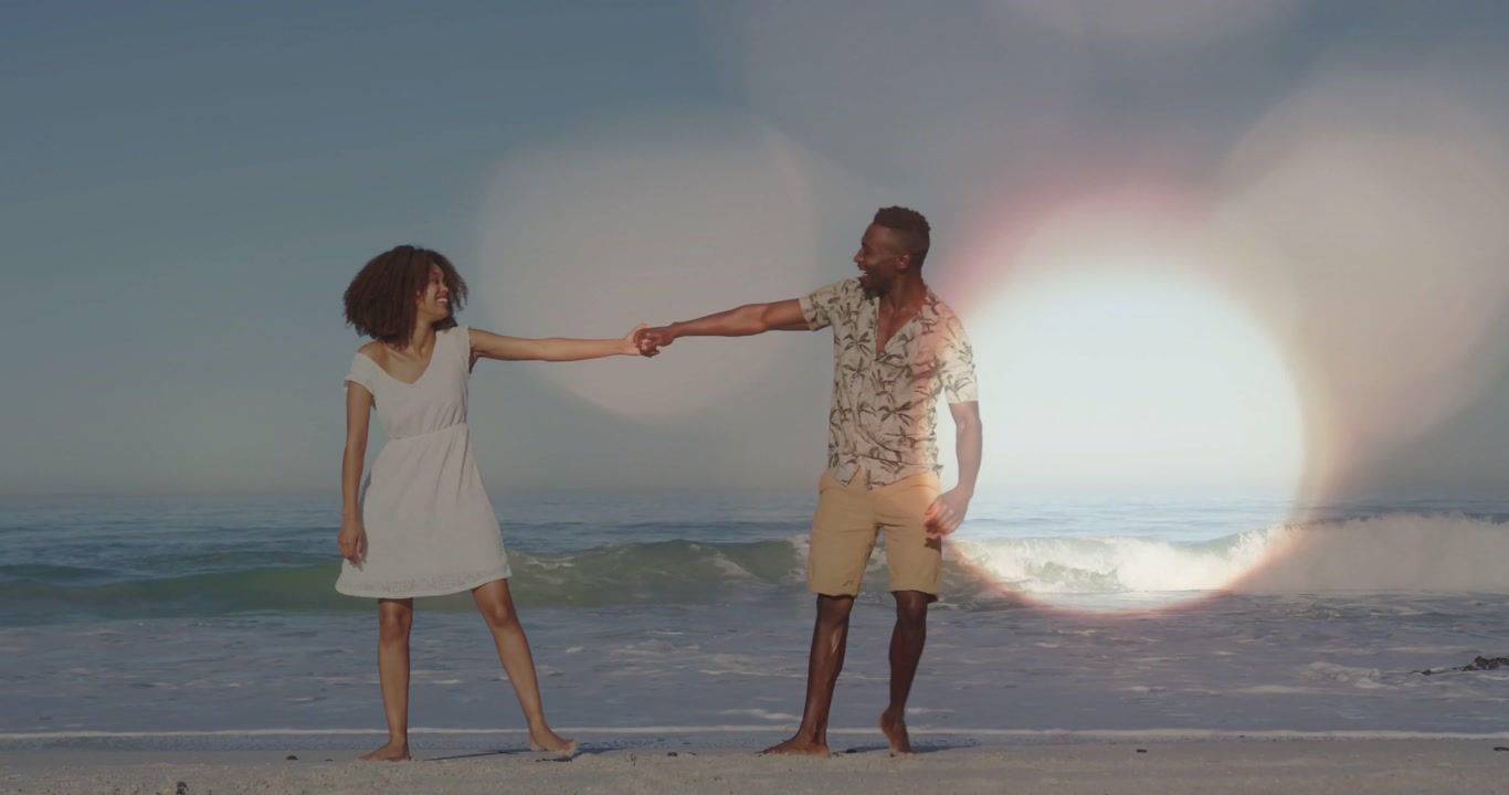 Woman and man holding hands man pulling woman walking beach light leaks drifting giving travel mood