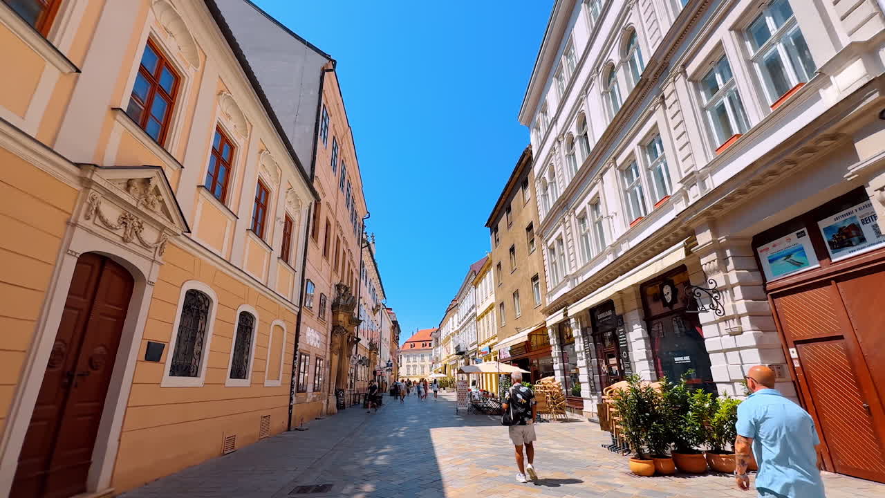 Bratislava, Slovakia, 2 June 2025: Tour by the beautiful street with gorgeous buildings in the historical part of the town. A walk by the old town in Bratislava, Slovakia on sunny day