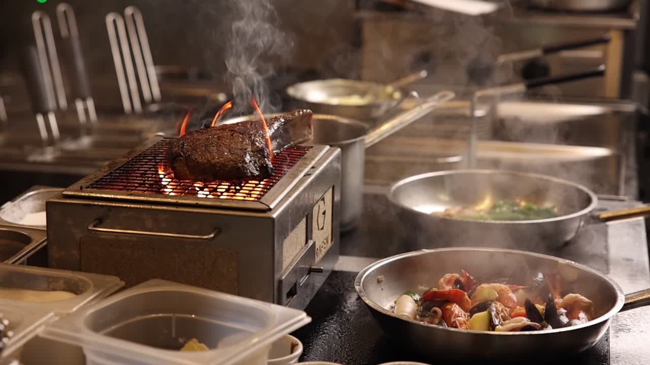 Chef Grilling Steak and Cooking Seafood in a Professional Kitchen
