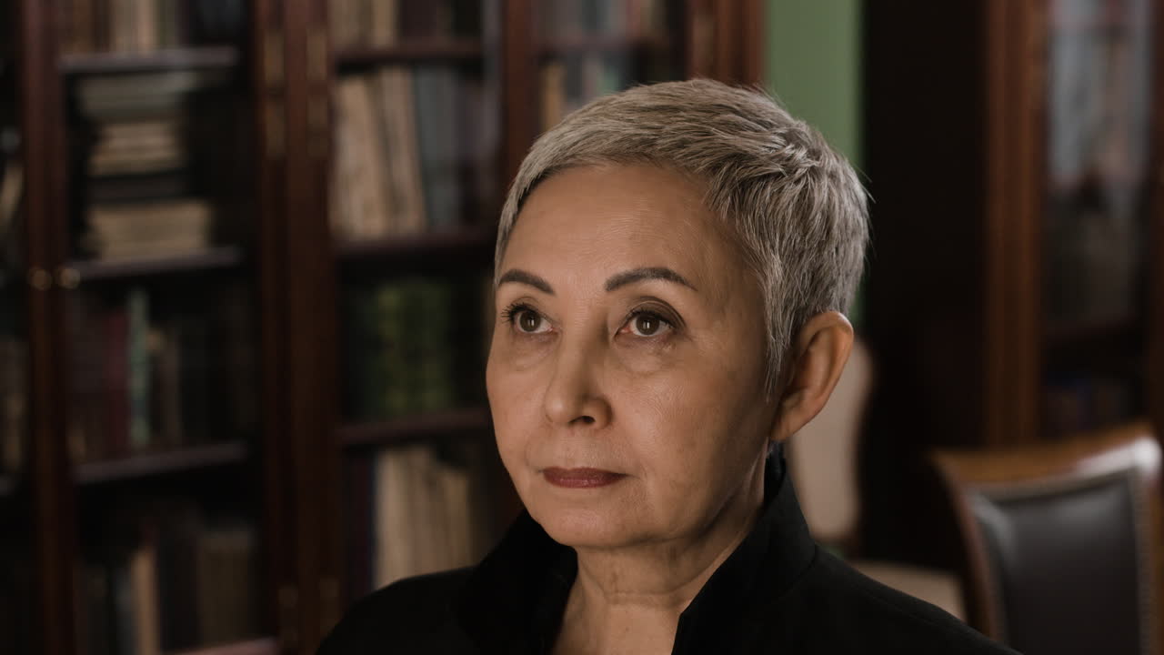 Thoughtful Senior Woman in a Library