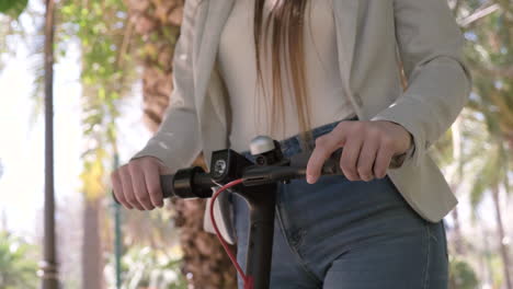 Close-Up-Of-An-Unrecognizable-Woman-Riding-Electric-Scooter-In-The-City-1