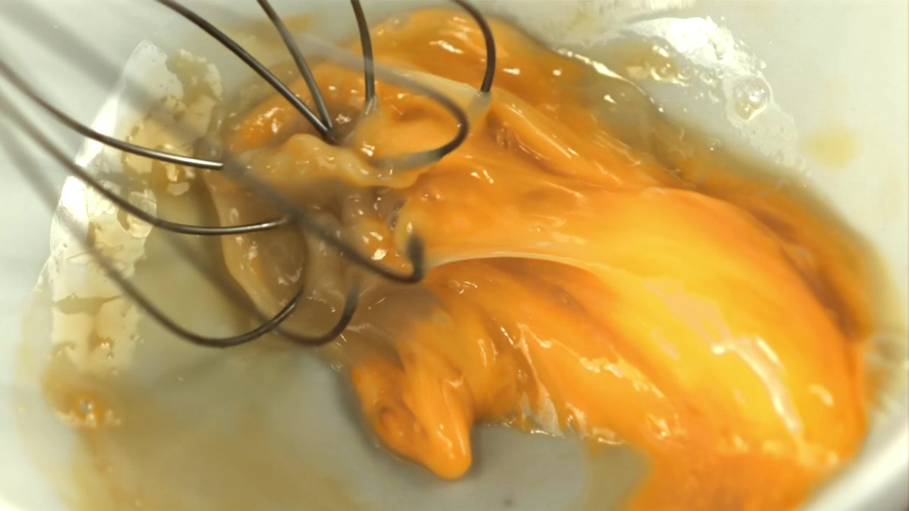 Slow Motion Whisking of Fresh Eggs in a Bowl