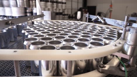 empty aluminum cans bottleneck at conveyor belt during bottling production assembly line for filling, hd