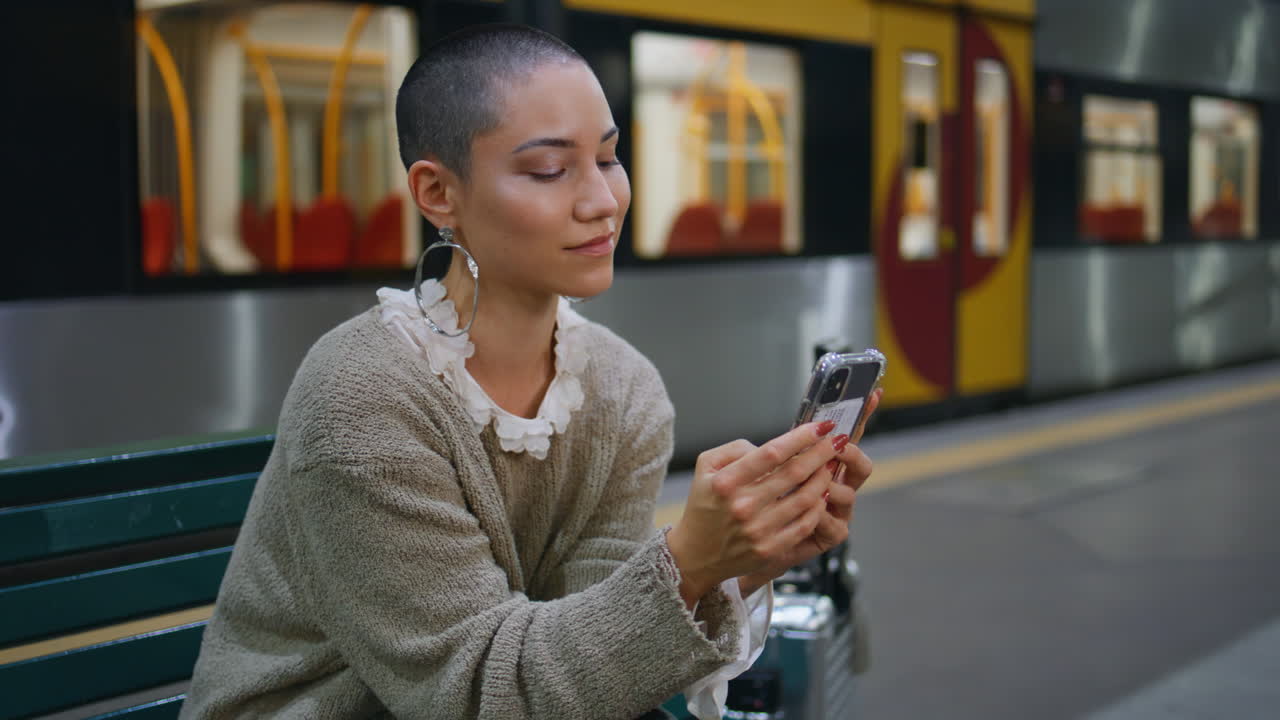 Woman using smartphone at train station