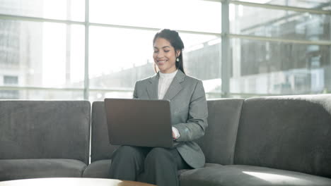 Laptop,-sofa-and-woman-in-office-lobby-checking