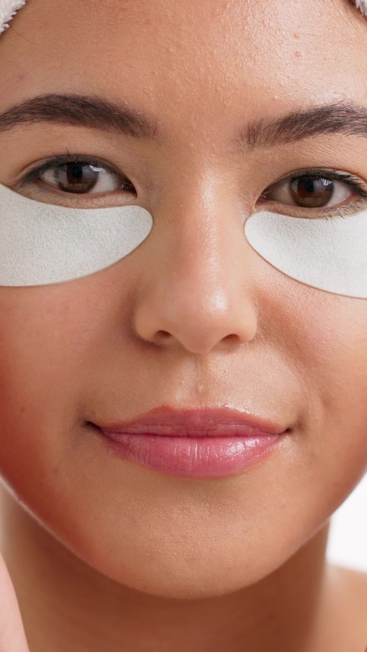 Young Woman Applying Under Eye Patches for Skincare Routine