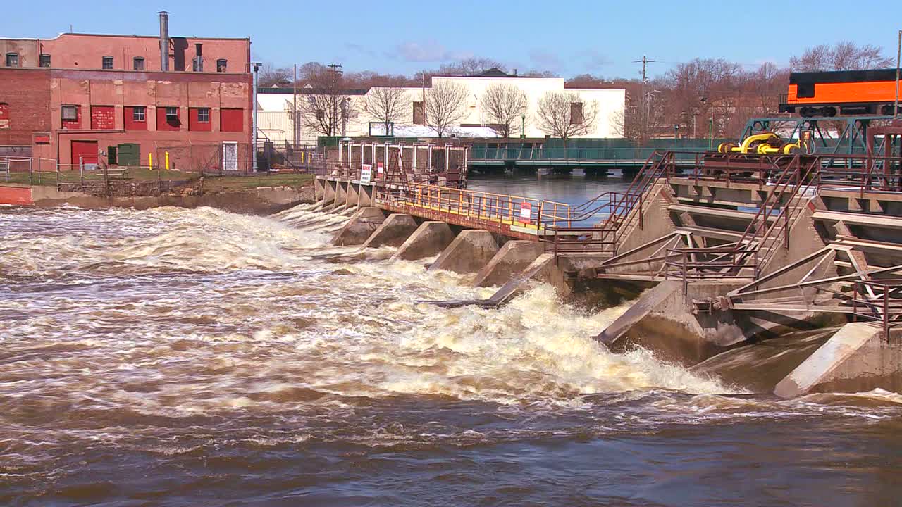 A dam handles fast flowing water in a river