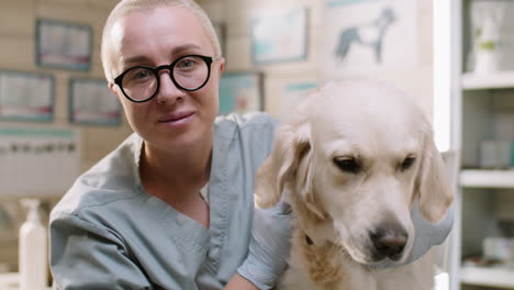 portrait of female vet with dog in clinic