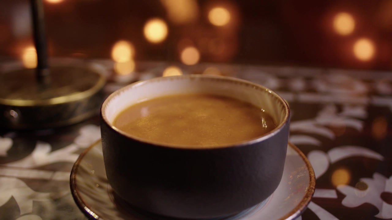 Tazón caliente de sopa de lentejas tradicional humeante en una mesa de un auténtico restaurante turco.