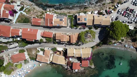 top down view of houses on greece peninsula on a sunny day, aerial rising