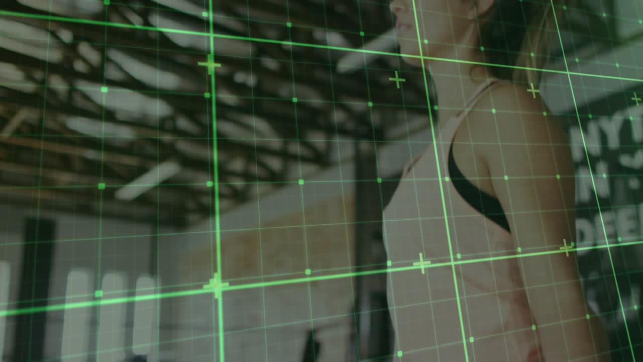 Woman gripping jump rope in gym pivoting wrists rotating with green grid, preparing jump exercise