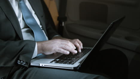 close up of male hands typing on laptop