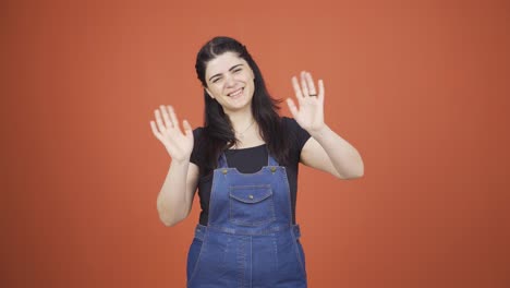 happy woman waving at camera.