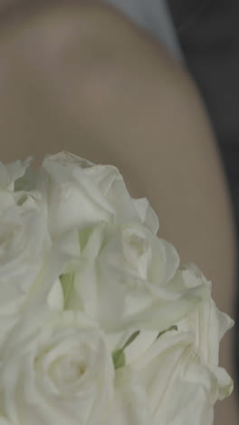 beautiful bride holding bouquet of roses and laughing