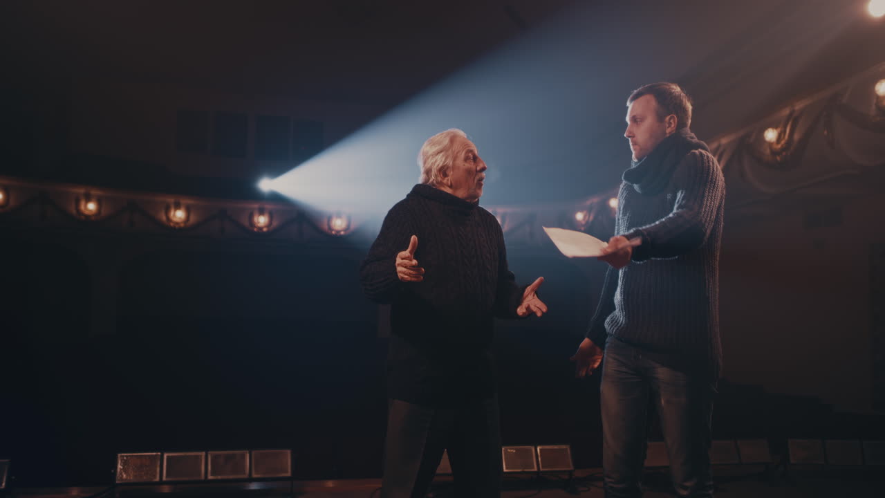 Man and Woman Acting out Quarrel with Director Young Actress in Glasses Screaming at Actor then Throwing Script and Walking Away while Rehearsing Argument Scene with Senior Director on Stage in Theater