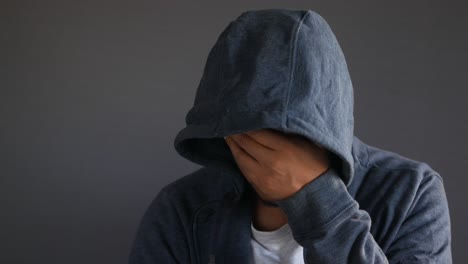 man with hood down, hiding face