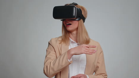 Business-woman-use-virtual-reality-headset-helmet-to-play-simulation-game-app-watching-video-content