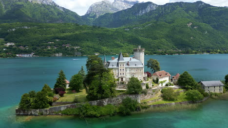 orbit drone shot of duingt castle during the day with lake annecy in haute-savoie, france