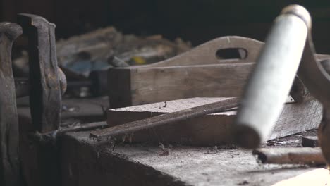 Old-woodworking-tools-on-dusty-workbench-in-close-up-view