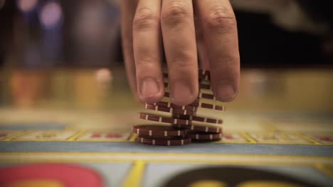 roulette playing with chips, close up chips in casino, close up hands of croupier