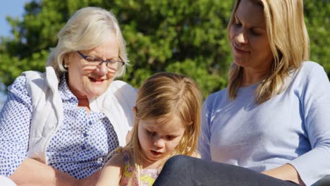 multi-generation family using laptop in the garden 4k