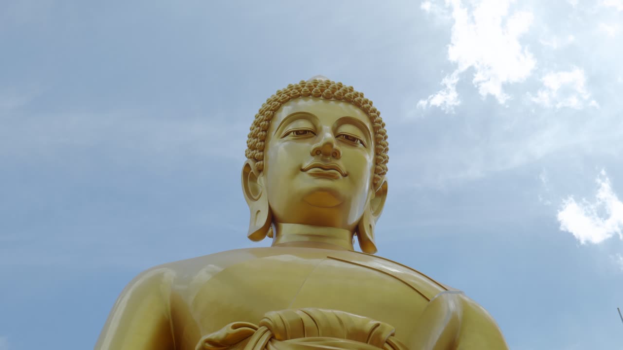 Footage of the majestic Big Buddha golden statue inside Wat Paknam Phasi Charoen Temple in Bangkok, Thailand. The video captures the intricate details of the statue and the sacred interior