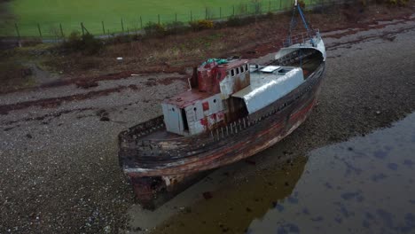 old boat of caol on shores of loch linnhe in fort william, scotland