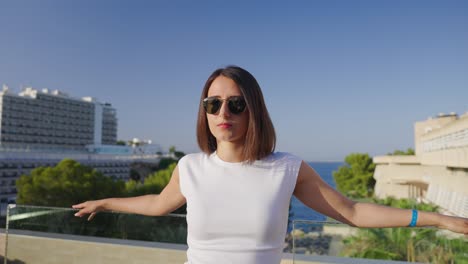 woman enjoying a scenic sea view from a hotel balcony