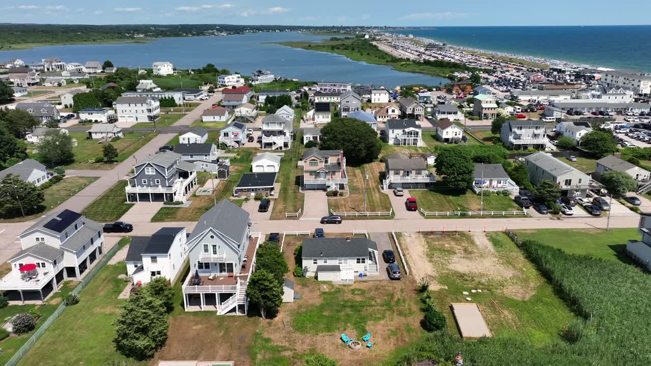 Houses and homes with solar panels in Misquamicut, Rhode Island.sunny summer day with winnapaug pond and ocean water. Luxury buildings near beach. drone flyover shot