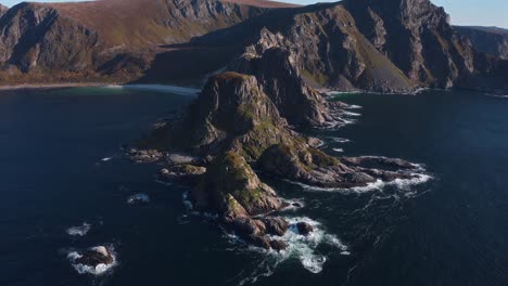 rocky mountain peaks surrounded by the ocean, viewed from above, måtinden in norway