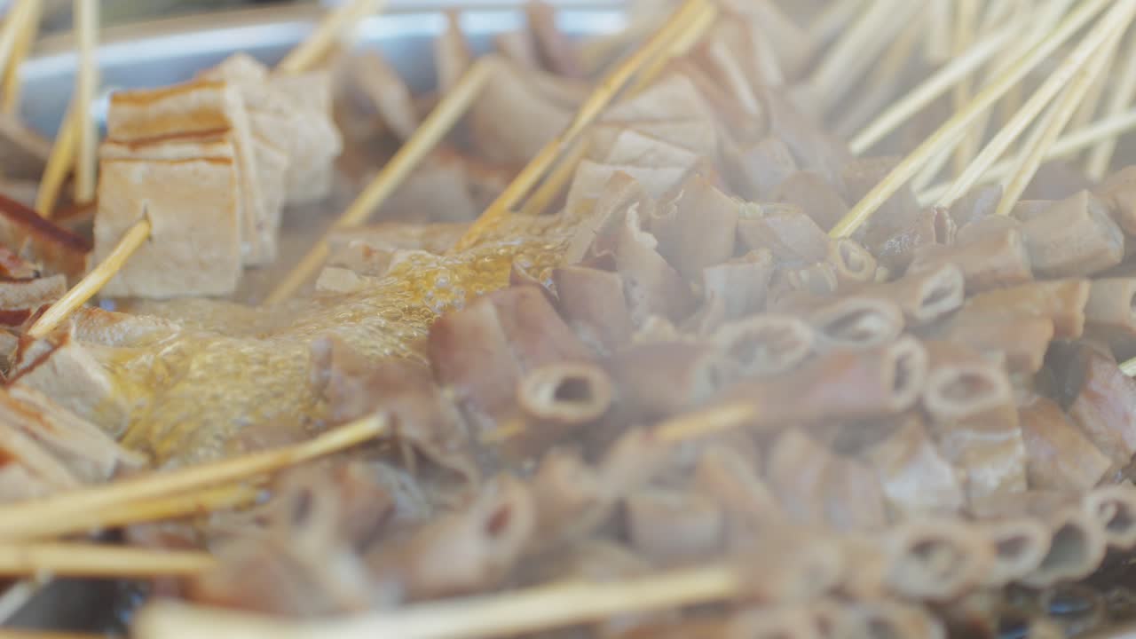 Traditional chinese spicy chicken gizzards close-up. Asian chicken stomach popular food. Local street food market outdoor. High quality 4k footage