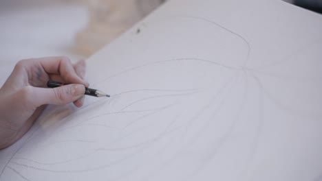 close up of person sketching with a pencil on paper, sketch done with wooden pencil in artsy style and manner