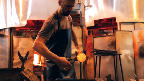 glassblower shaping a molten glass