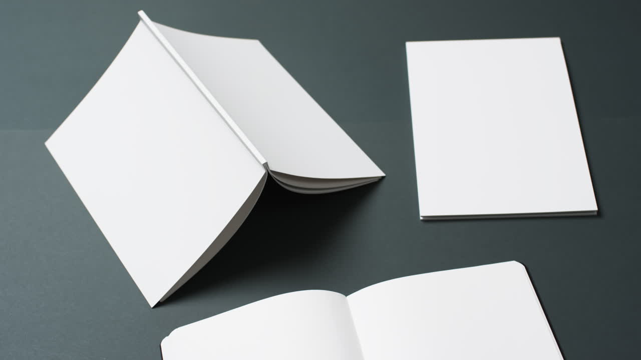 Video of books with white blank pages and copy space on black background
