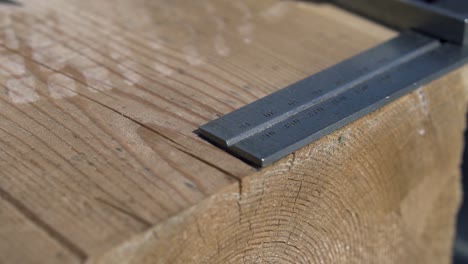 Measuring Wood Plank with Square and Pencil