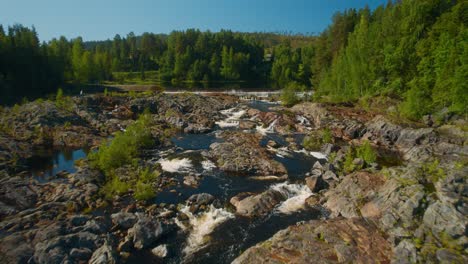 flying over some rapids and a dam