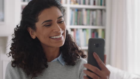 Hermosa-Mujer-De-Raza-Mixta-Teniendo-Video-Chat-Usando-Un-Teléfono-Inteligente-Riéndose-Sorprendida-Disfrutando-De-Buenas-Noticias-Charlando-Con-Un-Amigo-Por-Teléfono-Móvil-En-Casa-Imágenes-De-4k