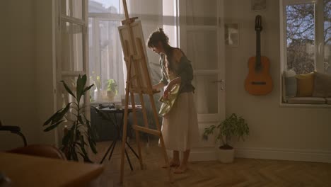 woman painting in a home studio