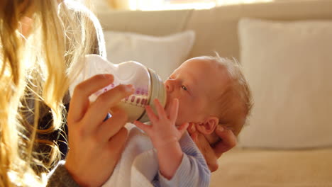 mother feeding her baby at home 4k