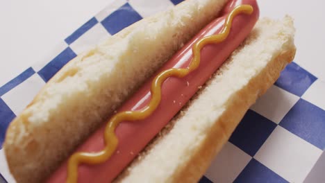 Video-of-hot-dog-with-mustard-on-a-white-surface