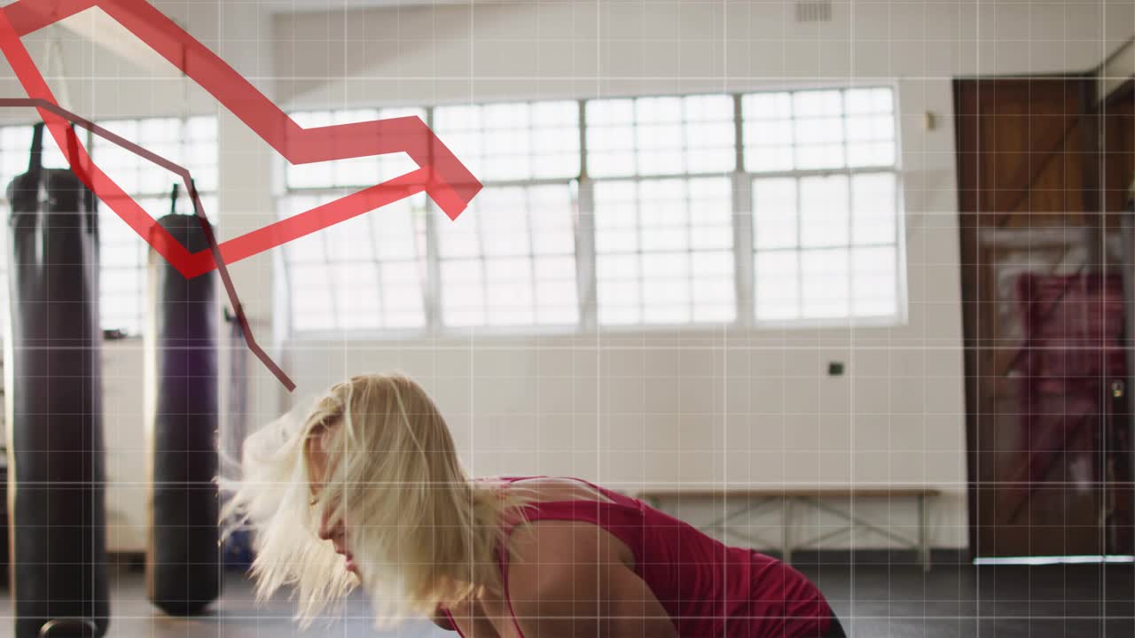 Woman gripping kettlebell, initiating swings for fitness, red graph tracking power over torso