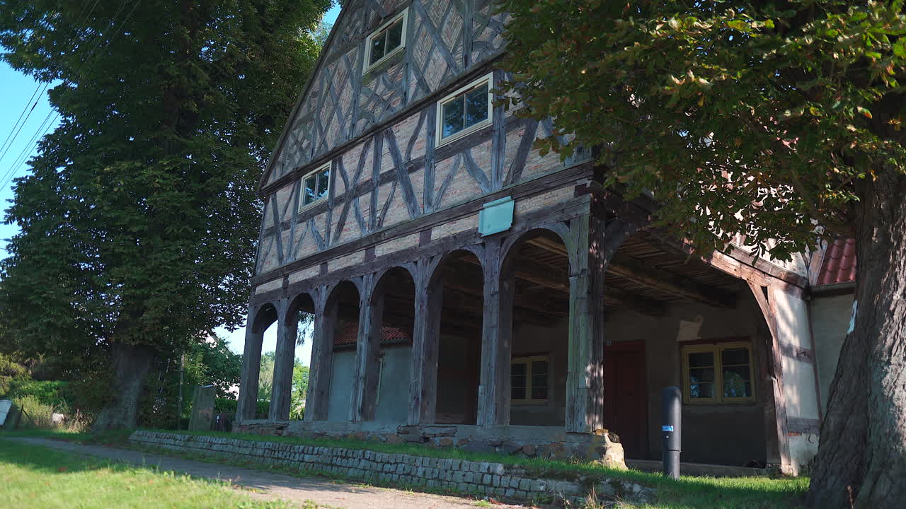 Looking up to Charming Mennonite arcade house in Poland's historic town, a glimpse of timeless architecture