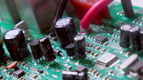 Close-up-of-circuit-board-components-under-a-thorough-inspection-of-an-expert-technician