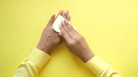 person cleaning hands with a cloth