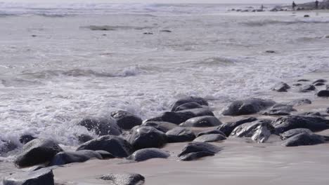 stones and rocks in the sand polished smooth the ocean waves - beach in crescent head, nsw - close up