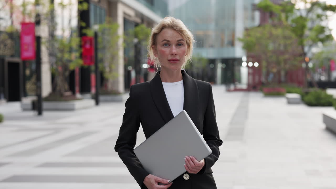 Businesswoman with Laptop in Urban Setting